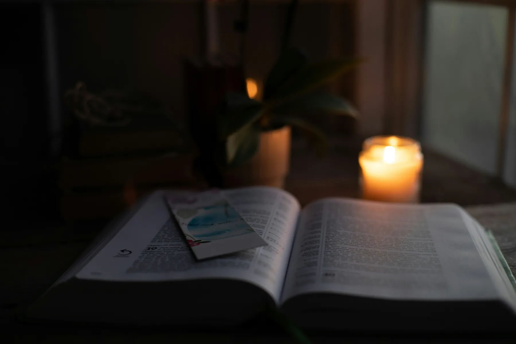 An open Bible by candlelight