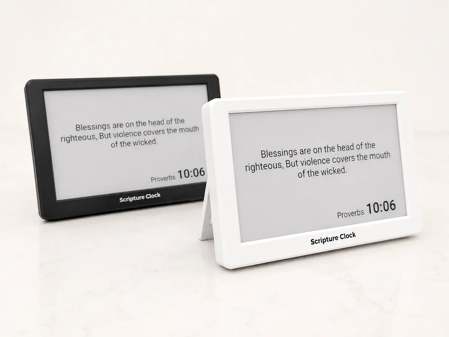 Two Scripture Clocks — matte white and matte black — side by side